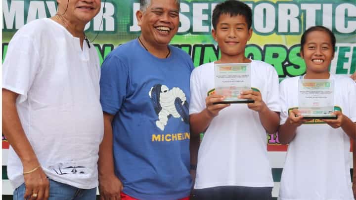 AYL Gonzaga (right) beams as she and Julius Otoc hold their trophies after clinching MVP honors in the PPS-PEPP national juniors tennis in Davao del Sur. Also shown are (from left) Digos Tennis Club officer Paul Basan and Ray Anthony Loyola, organizer and consultant for City Sports Development.