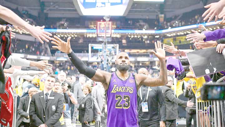 LeBron James and his fans celebrate his tip-in that gave the Los Angeles Lakers a 120-119 win over the Indiana Pacers in their NBA regular season game.