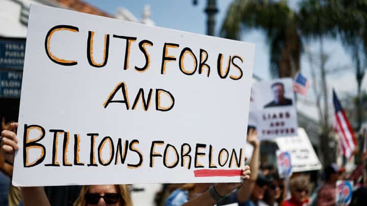 PASADENA, CALIFORNIA - Protesters demonstrate against Tesla CEO Elon Musk’s Department of Government Efficiency (DOGE) initiatives during a nationwide “Tesla Takedown” rally outside a dealership on 29 March 2025 in Pasadena, California. Protesters in more than 30 states nationwide are demonstrating against the Department of Government Efficiency during what organizers are calling a global day of action.