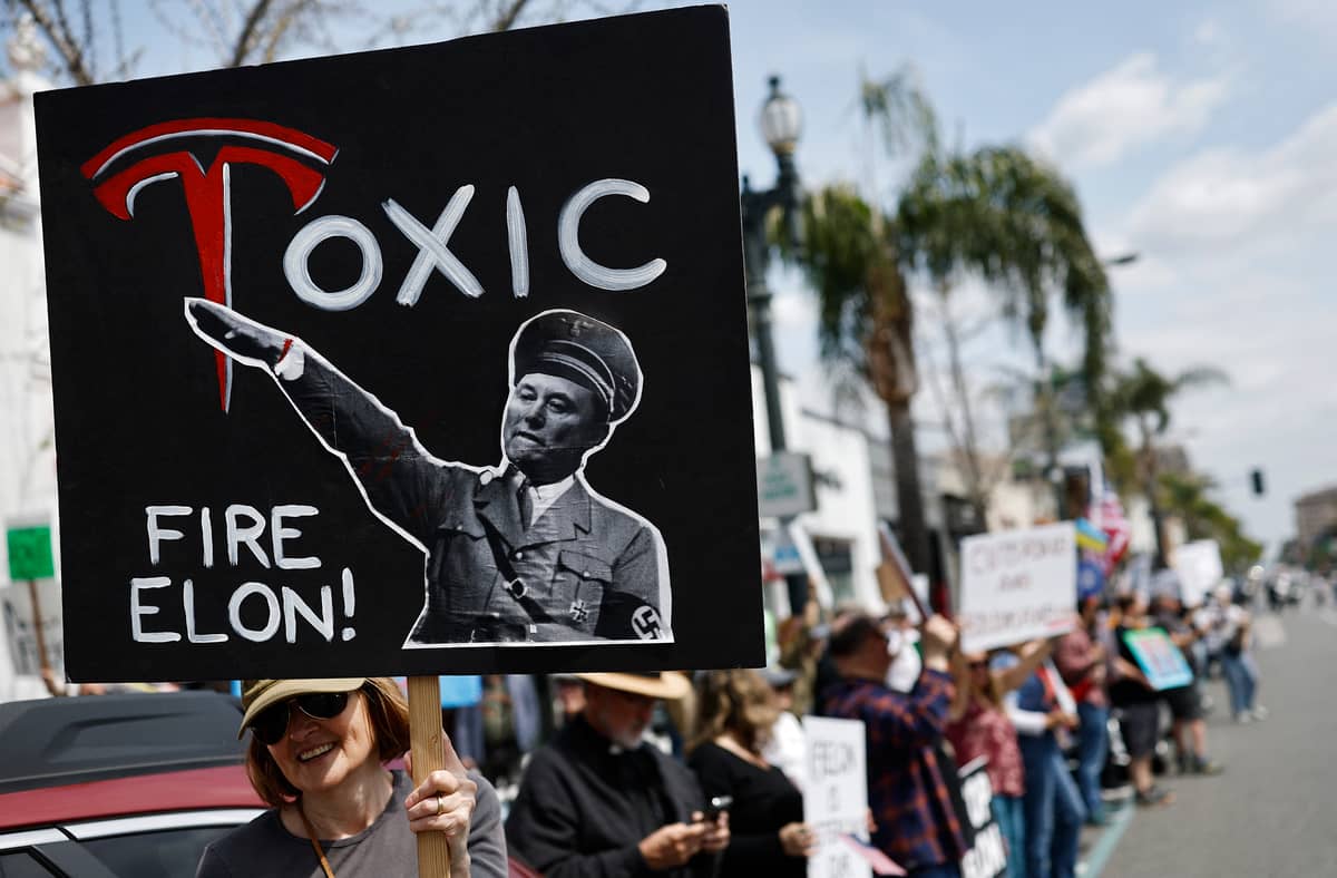 PASADENA, CALIFORNIA - MARCH 29: Protesters demonstrate against Tesla CEO Elon Musk’s Department of Government Efficiency (DOGE) initiatives during a nationwide “Tesla Takedown” rally outside a dealership on March 29, 2025 in Pasadena, California. Protesters in more than 30 states nationwide are demonstrating against the Department of Government Efficiency during what organizers are calling a global day of action.