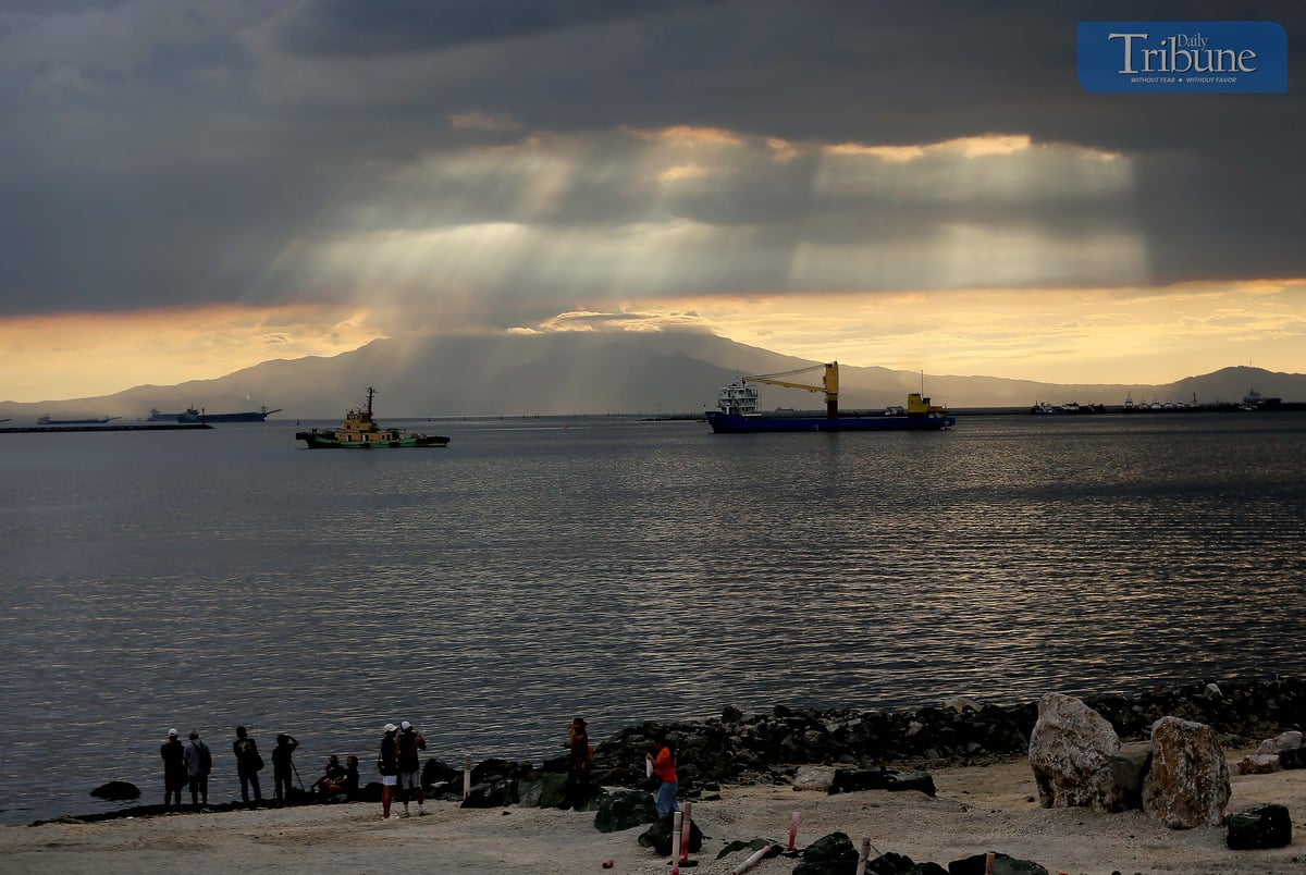 Local tourists spend time at Dolomite Beach at Manila Bay in Manila to watch the sunset on Sunday, 30 March 2025.