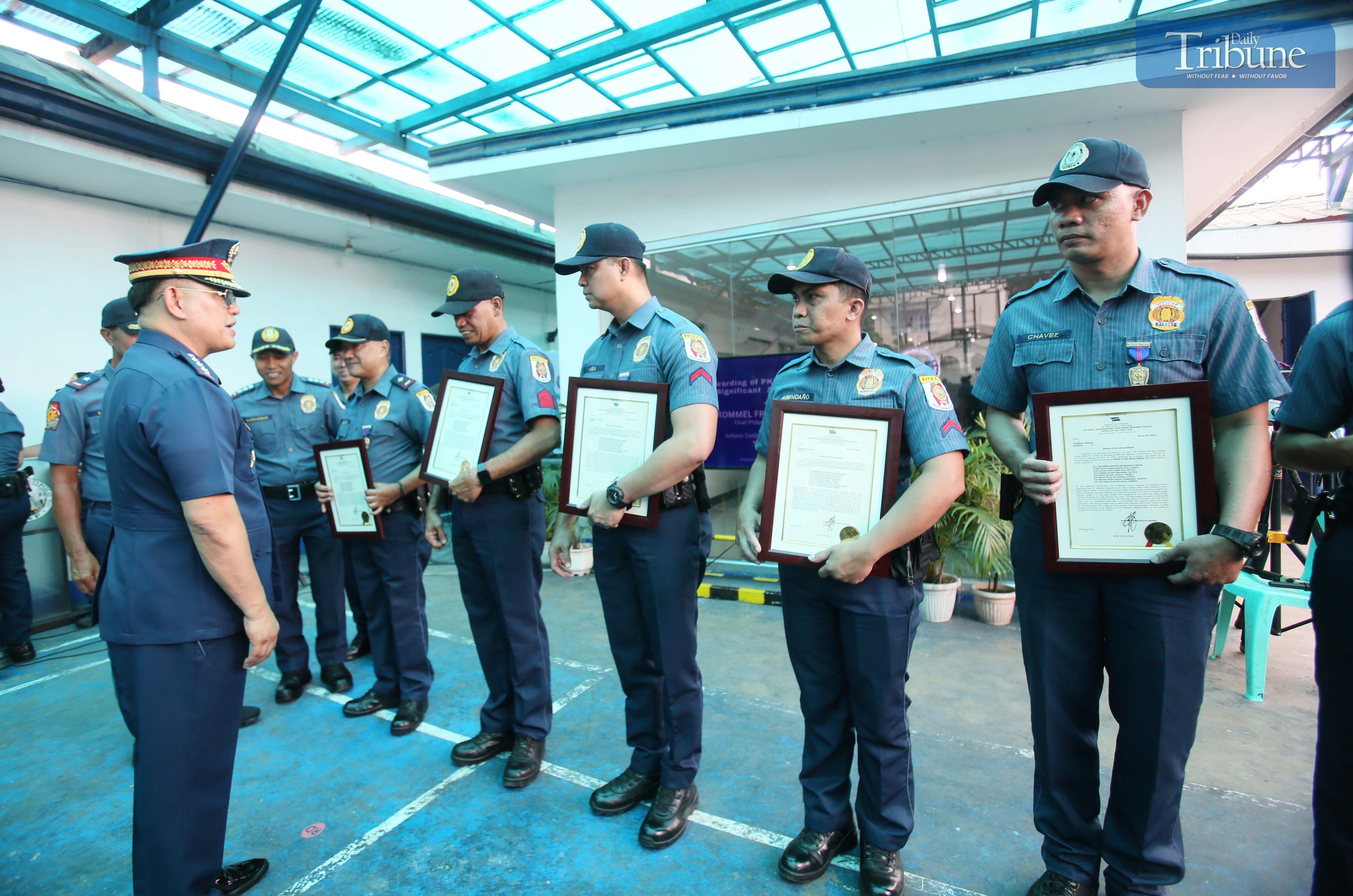 PNP Chief Rommel Marbil congratulates eight Antipolo police personnel during a medal awarding ceremony at the Antipolo Component City Police Station on Monday, 31 March 2025. The recognition was for their swift arrest of a suspect involved in a road rage incident along Marcos Highway in Sitio Calumpang, Barangay San Jose, Antipolo, on Sunday afternoon.