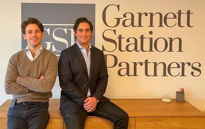 Matt Perelman and Alex Sloane, co-founders of Garnett Station Partners, at their shared office desk where they've built a multibillion-dollar private equity firm from the ground up.