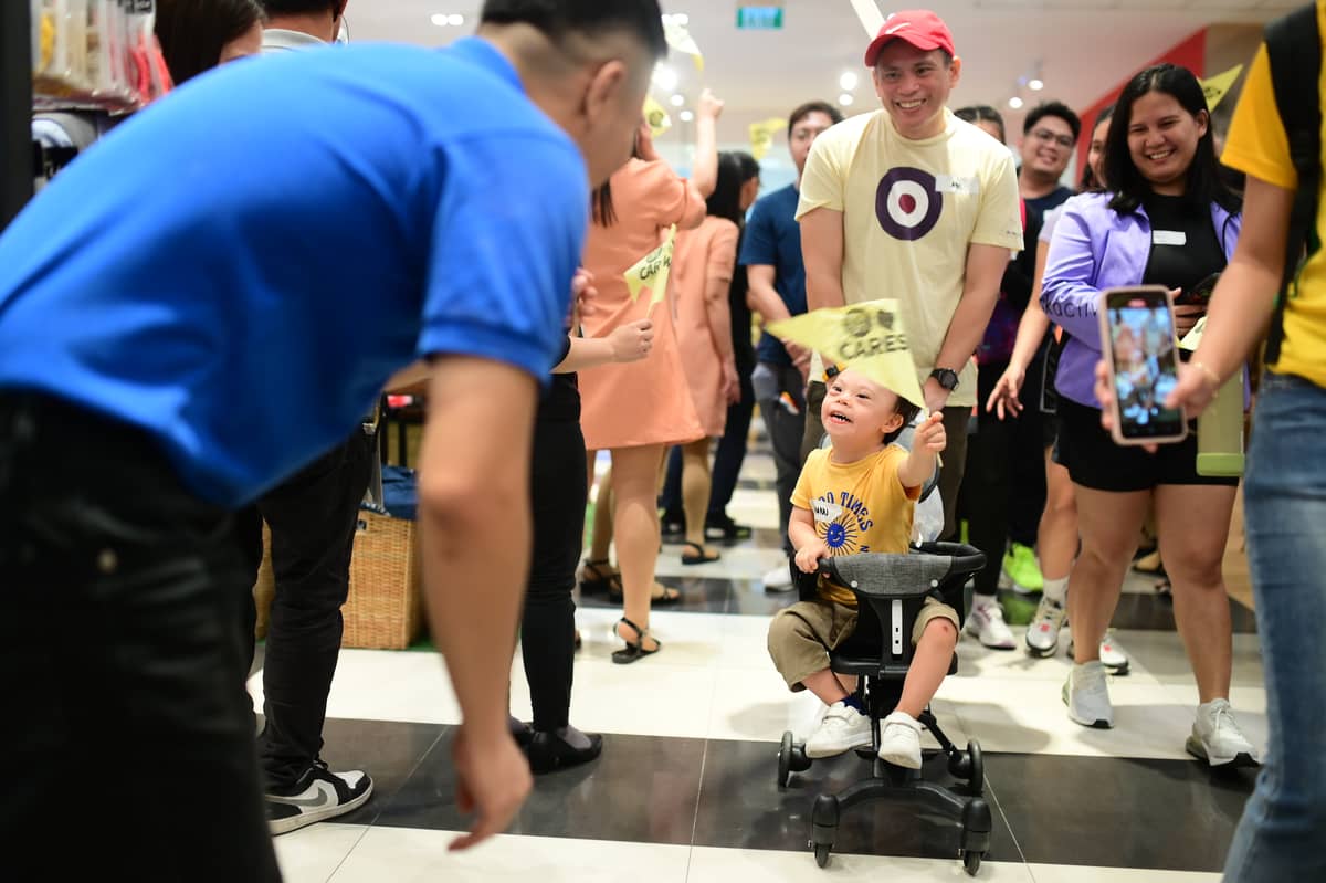 Waving their Happy Walk flaglets, SM employees and tenant personnel give a warmest welcome to the Down Syndrome community.