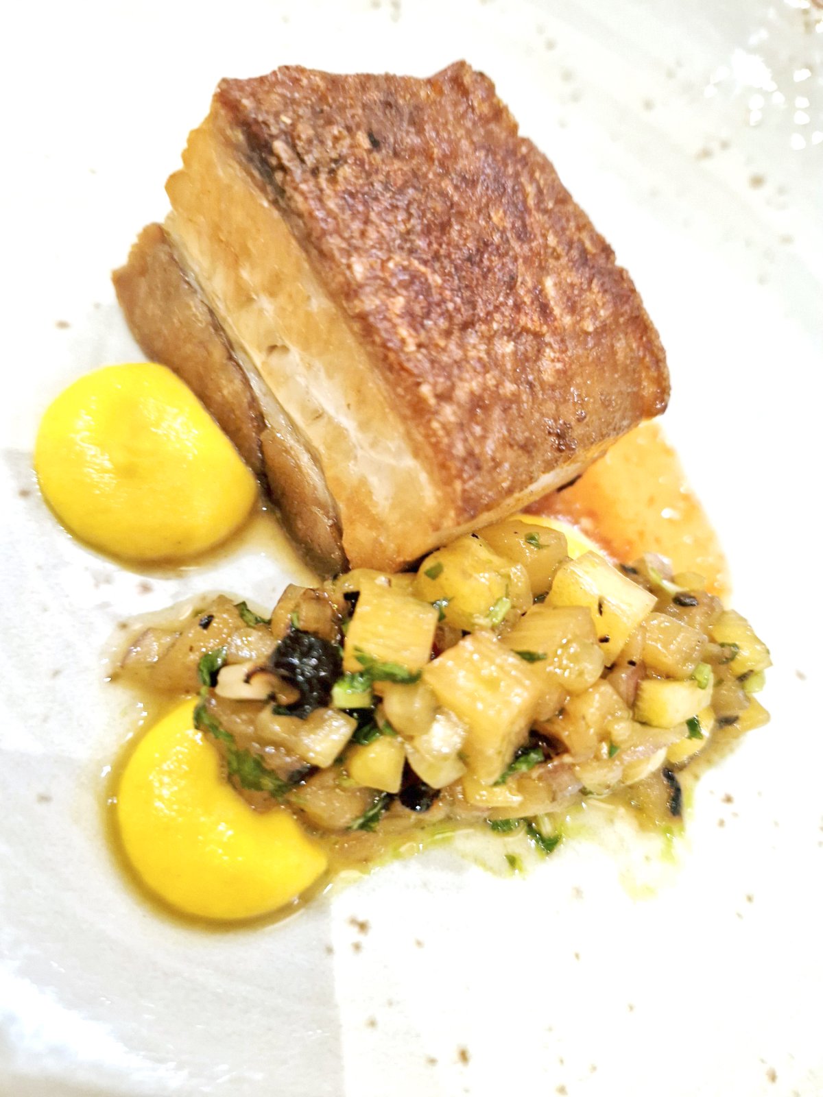 Crispy pork belly, carrot habanero, grilled and fresh pineapple salad.