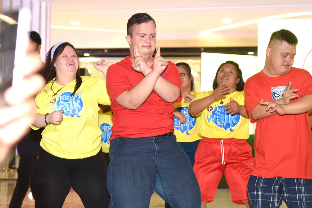 SM City Cebu’s happy walkers showcase their awesome dance moves onstage, embracing their abilities.