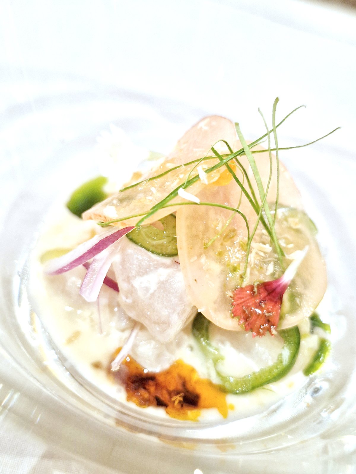 Lapu-lapu ceviche with coconut milk, yuzu, makrut lime leaves, lemongrass oil, jalapeño, chile crisp, and radish for crunch.