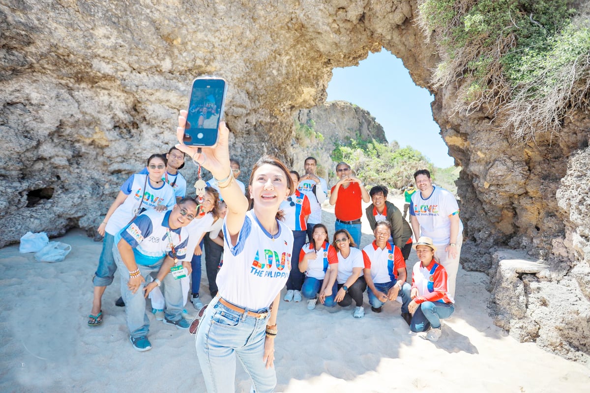 Tourism Secretary Christina Garcia Frasco takes a selfie with the Philippine Experience Program of the Department of Tourism participants at Morong Beach in Sabtang.