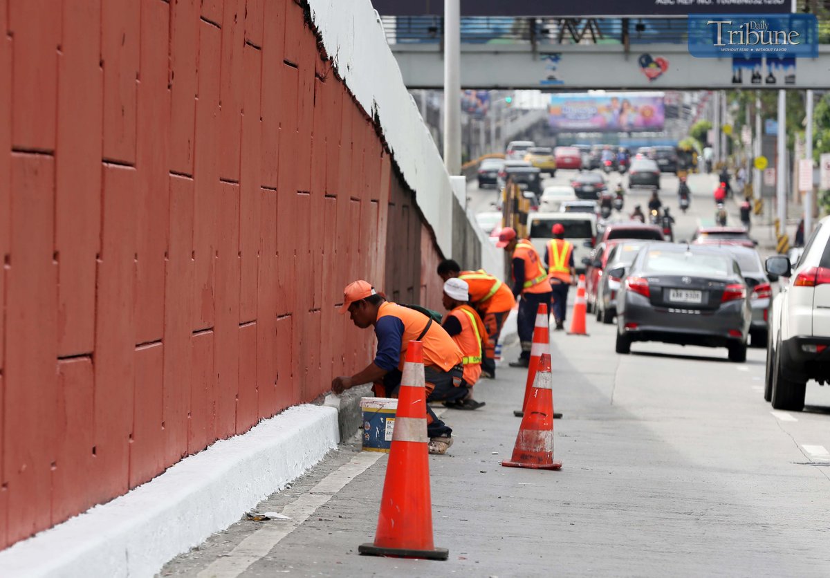 With fewer motorists on Edsa during the holiday break, DPWH workers repaint the Kamuning Flyover on Wednesday, 9 April 2025.