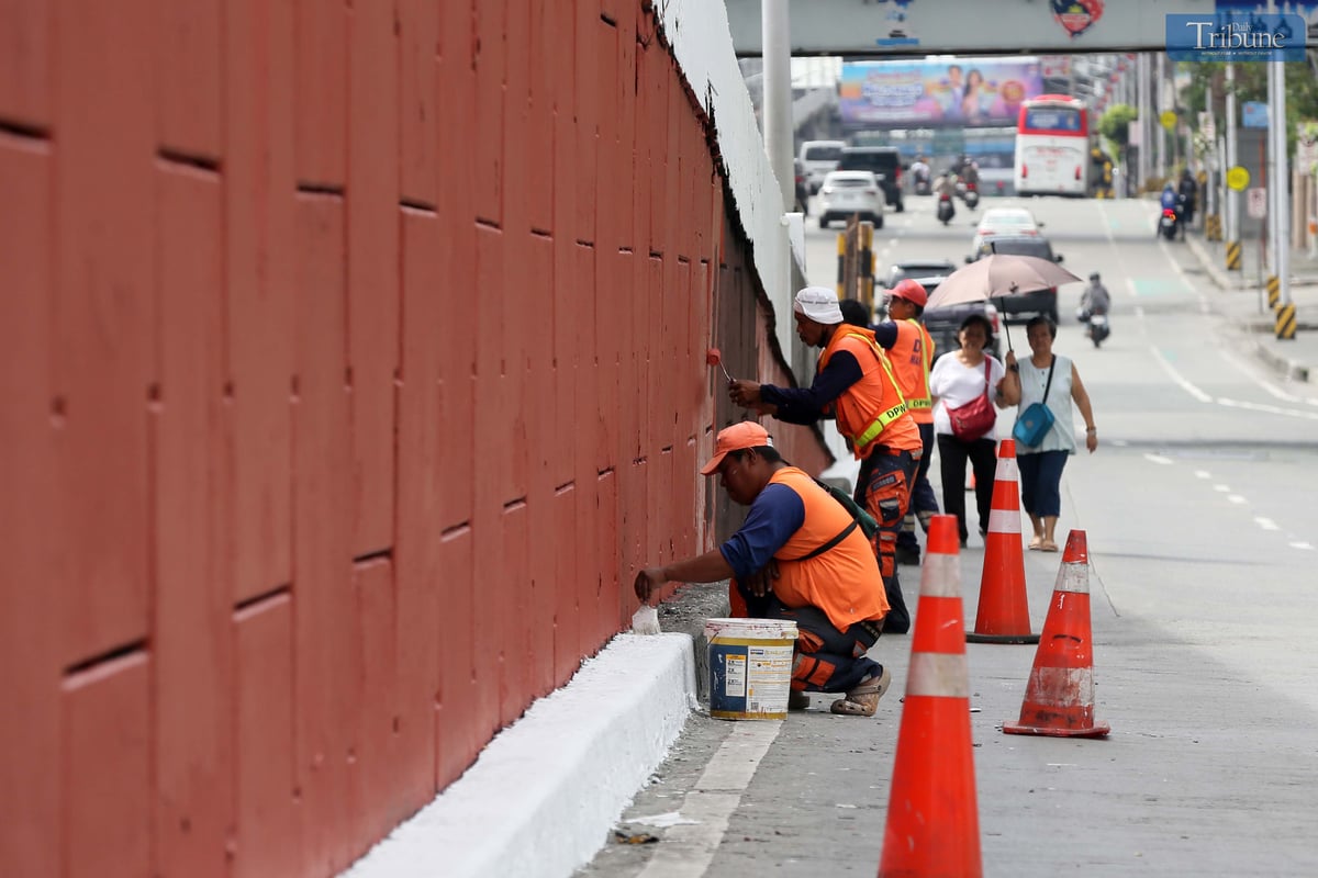 With fewer motorists on Edsa during the holiday break, DPWH workers repaint the Kamuning Flyover on Wednesday, 9 April 2025.
