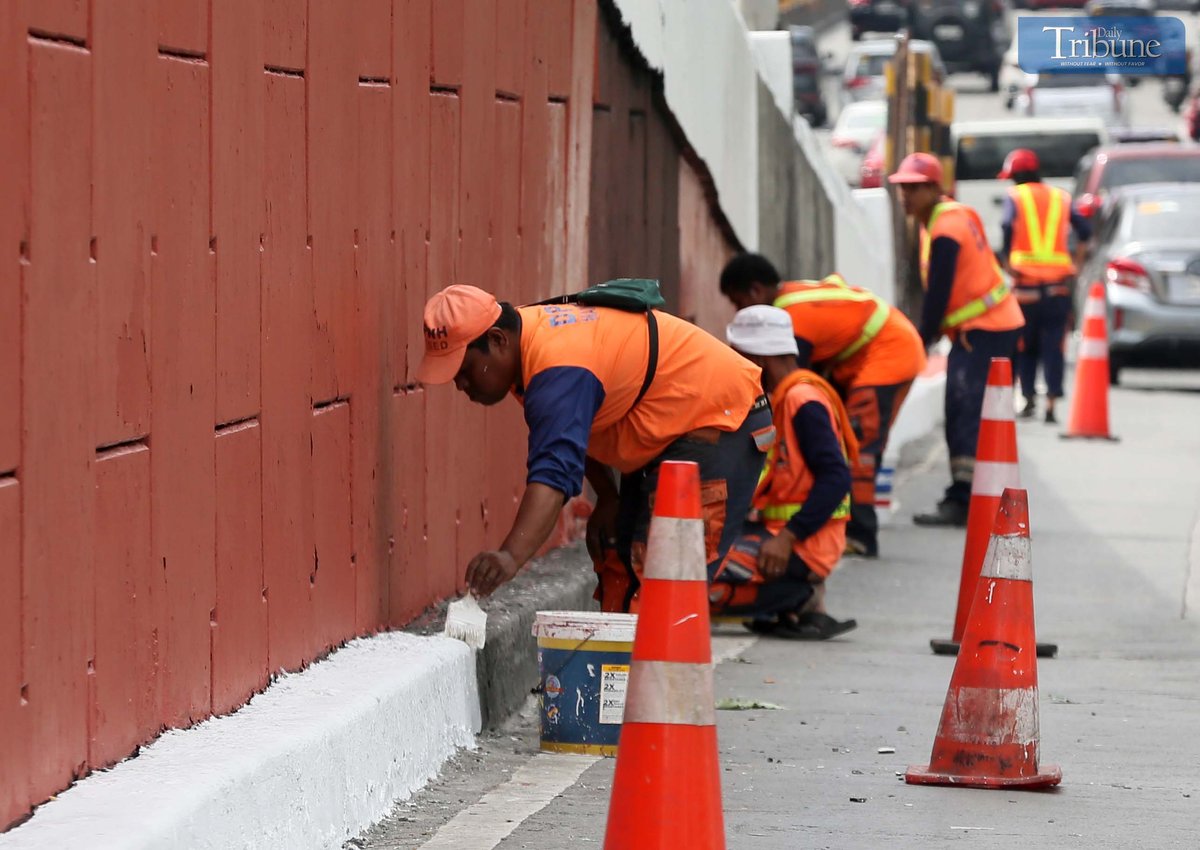 With fewer motorists on Edsa during the holiday break, DPWH workers repaint the Kamuning Flyover on Wednesday, 9 April 2025.