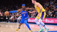 Shai Gilgeous-Alexander fends off Luka Doncic in Oklahoma City's 136-120 win over the Los Angeles Lakers