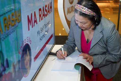 Author Elvira Silla signs copies of her cookbook Ma Rasah: My Self-Trained Home Chef during its launch at Book Nook SM Aura, in partnership with BookshelfPH.