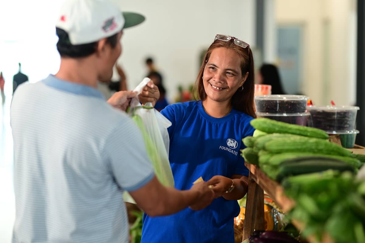 Mercy Pacat, leader of the EFA, sells vegetables at the SM City Bataan.
