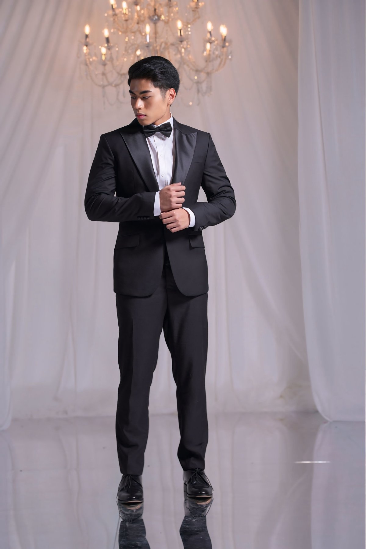 Single-breasted peak lapel italian wool fabric slim cut tuxedo with Egyptian cotton long sleeves accessorized with silk bowtie and cummerbund.