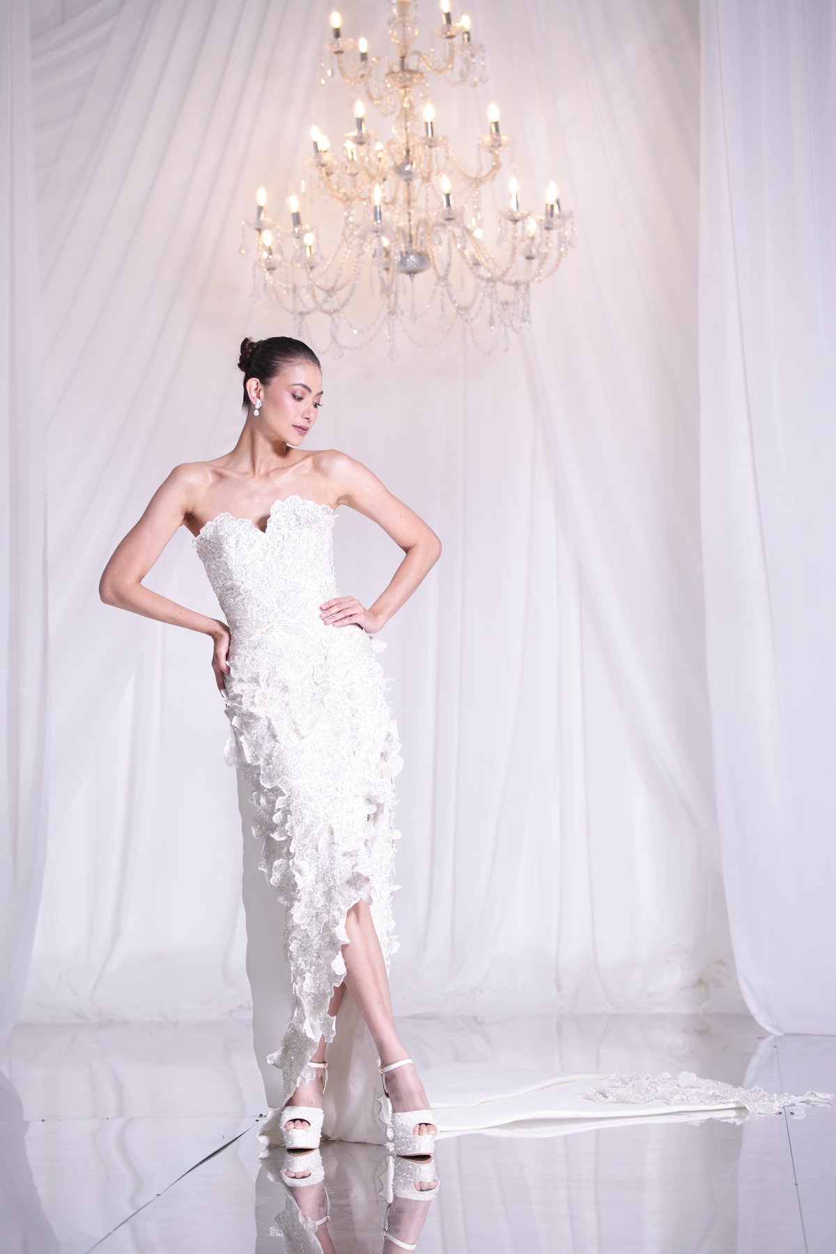 Heart-shaped bustier column high-slit gown with fully beaded floral lace applique and a detachable train.