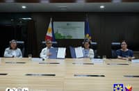 Energy Secretary Raphael PM Lotilla (second from left) and Energy Regulatory Commission chairperson Monalisa Dimalanta (third from left) show the signed landmark data sharing agreement. With them are Energy Undersecretary Rowena Cristina Guevara (left) and ERC executive director Nancy Aurora Fajardo (right).
