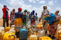 Sudanese refugees fill jerry cans with water at the Touloum refugee camp in the Wadi Fira province, Chad, on April 8, 2025. Sudan's civil war has resulted in "13 million displaced people and refugees", including many women who reported being raped and children, a regional UNHCR official told AFP on April 14, 2025.