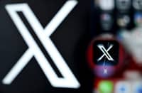 A photo shows the logo of US online social media and social networking service X - formerly Twitter - on a smartphone screen.