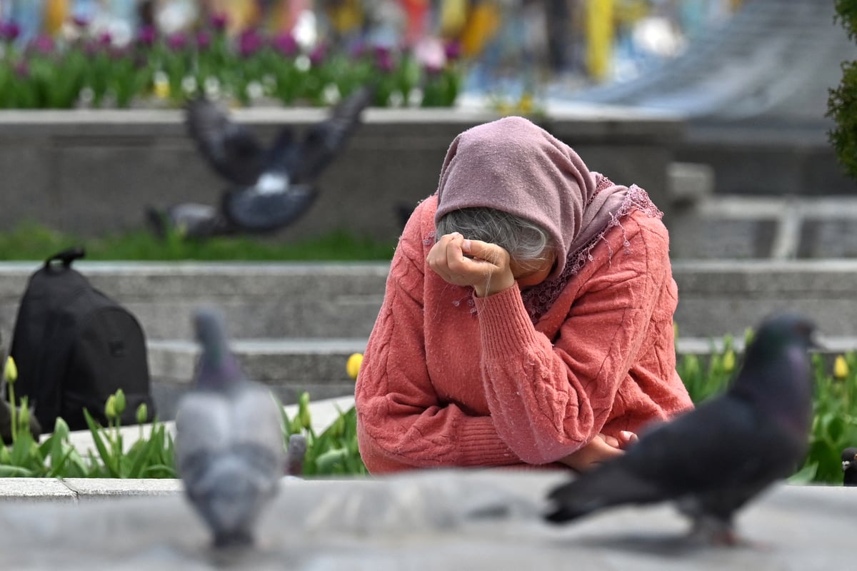 An elderly woman reacts in front of makeshift memorial for the fallen Ukrainian and foreign fighters, at the Independence Square in Kyiv on 19 April 2025, amid the Russian invasion of Ukraine. Russian President Vladimir Putin on Saturday announced an Easter truce in the conflict in Ukraine starting this evening and lasting till midnight on Sunday.