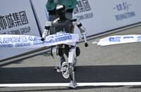 A robot crosses the finish line in the humanoid robot half marathon in Beijing