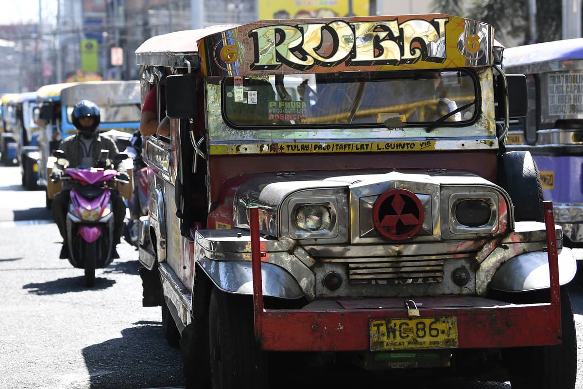 Jeepneys and scooters along the road, forming part of the daily commute for Manila’s university students.