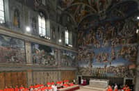 (FILES) This handout picture released by the Press office shows cardinals queuing in the Sistine Chapel to swear on the Bible to never reveal the secrets of their deliberations before the start of the conclave at the Vatican on 12 March 2013. Pope Francis died on 21 April 2025 aged 88, a day after making a much hoped-for appearance at Saint Peter's Square on Easter Sunday, the Vatican said in a statement.