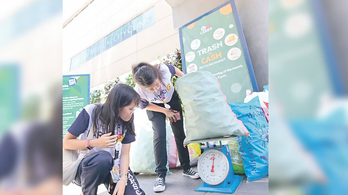 STUDENTS weigh recyclables during SM Cares’ Trash to Cash, showing that small actions can lead to a greener future.