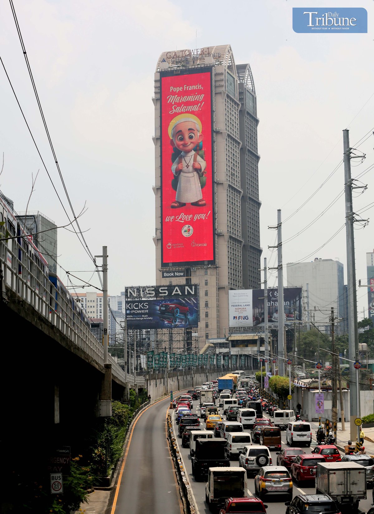 A cartoonized photo of Pope Francis is seen displayed on an electronic billboard along EDSA in Mandaluyong on Wednesday, 23 April 2025, two days after his passing at age 88. Remembered for his populist approach and efforts to reach people from all walks of life, Pope Francis leaves behind a legacy of compassion, humility, and dialogue.