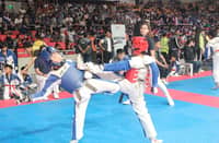 A player in blue armor (left) successfully defends an ax kick from an opponent during the SMART/MVPSF Taekwondo Summer Program that started last Monday.