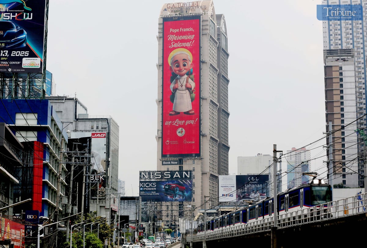 A cartoonized photo of Pope Francis is seen displayed on an electronic billboard along EDSA in Mandaluyong on Wednesday, 23 April 2025, two days after his passing at age 88. Remembered for his populist approach and efforts to reach people from all walks of life, Pope Francis leaves behind a legacy of compassion, humility, and dialogue.