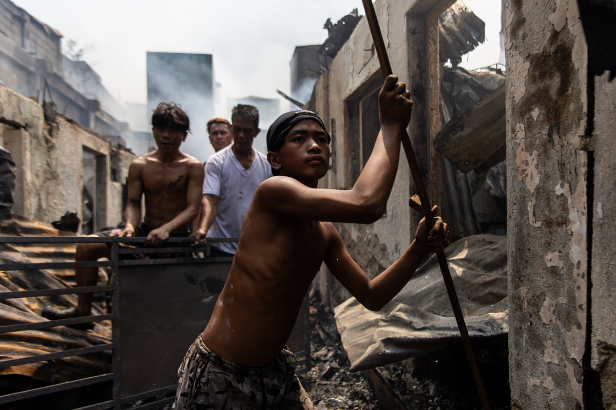 Scavengers returned to their homes after the fire was declared out around 7:00 AM, collecting any scraps they could sell to junk shops for money.