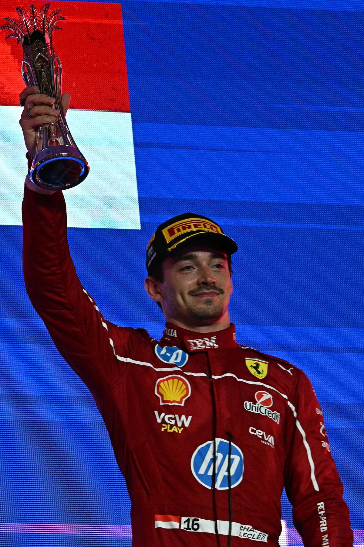THIRD-PLACED Ferrari’s Monegasque driver Charles Leclerc lifts the trophy on the podium following the 2025 Saudi Arabia Formula One Grand Prix.
