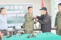 Path to peace A dramatic moment unfolds in Barangay Tual, President Quirino, Sultan Kudarat, as one of six surrendered rebels solemnly hands over his firearms to the 2nd Mechanized Infantry Battalion. This marks a significant step in the region's journey towards peace.