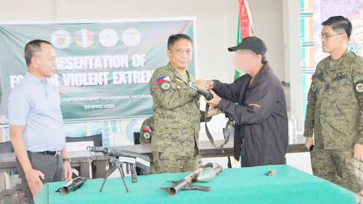Path to peace A dramatic moment unfolds in Barangay Tual, President Quirino, Sultan Kudarat, as one of six surrendered rebels solemnly hands over his firearms to the 2nd Mechanized Infantry Battalion. This marks a significant step in the region's journey towards peace.