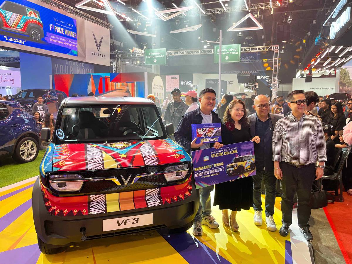 CELEBRATING his grand prize win, Filipino artist Trinidad poses with VinFast executives beside his boldly designed VF 3 ‘Lakbay.’ Shown are: (from left) Warren Carlo Trinidad, Doan Thi Mai Anh, CEO of VinFast Philippines; Abner Berdos, deputy CEO for Dealer Network; and Noel Ignacio, deputy CEO for Sales and Business Growth.