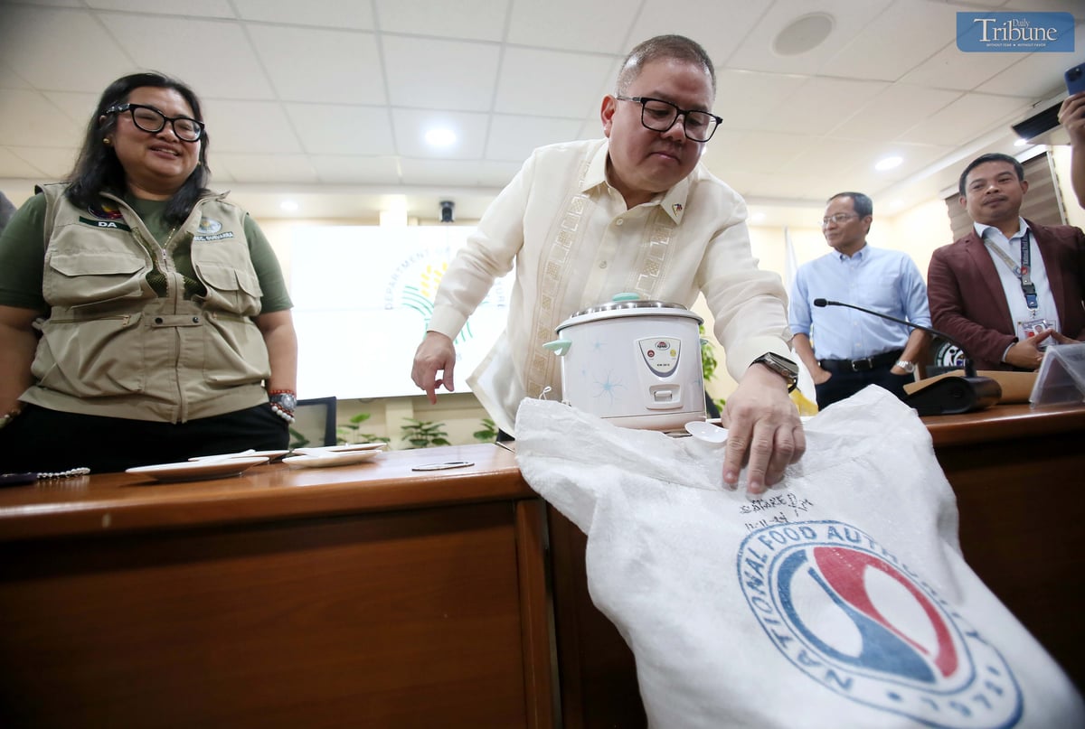 Department of Agriculture Secretary Francisco P. Tiu Laurel Jr., along with other officials, presents to the media a rice variety to be offered at P20 per kilo during a press conference at the DA head office in Quezon City on Tuesday, 29 April 2025. The demonstration aimed to highlight the rice’s quality and suitability for public consumption.