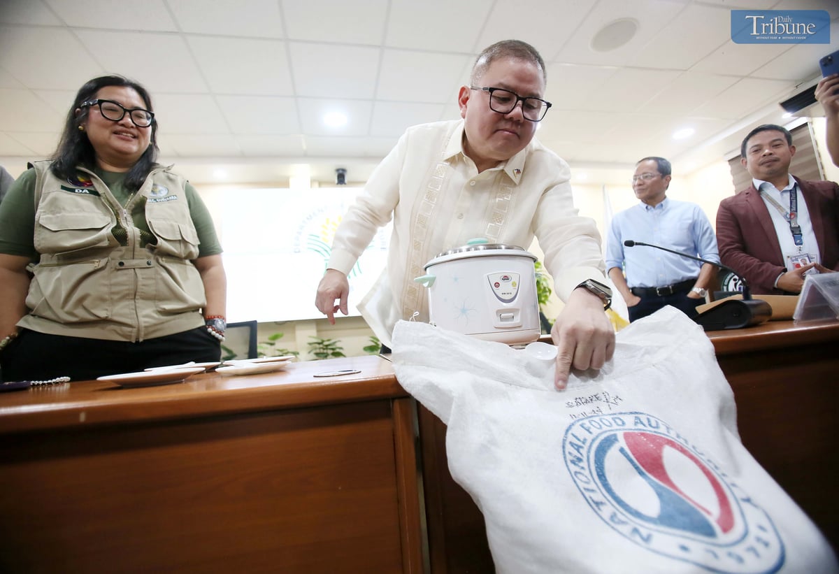 Department of Agriculture Secretary Francisco P. Tiu Laurel Jr., along with other officials, presents to the media a rice variety to be offered at P20 per kilo during a press conference at the DA head office in Quezon City on Tuesday, 29 April 2025. The demonstration aimed to highlight the rice’s quality and suitability for public consumption.