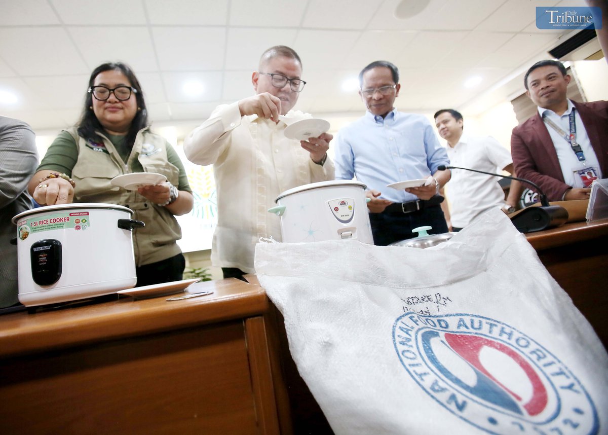 Department of Agriculture Secretary Francisco P. Tiu Laurel Jr., along with other officials, presents to the media a rice variety to be offered at P20 per kilo during a press conference at the DA head office in Quezon City on Tuesday, 29 April 2025. The demonstration aimed to highlight the rice’s quality and suitability for public consumption.