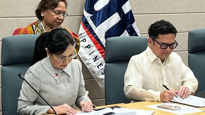 Trade Secretary Cris Roque (seated left) and IBPAP president and CEO Jack Madrid.