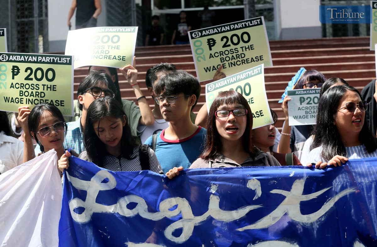 Hundreds of students join a solidarity walk organized by Akbayan Partylist for workers' rights at the University of the Philippines Diliman in Quezon City on Wednesday, 30 April 2025, vowing support for the passage of a P200 minimum wage hike, ahead of the Labor Day celebration.