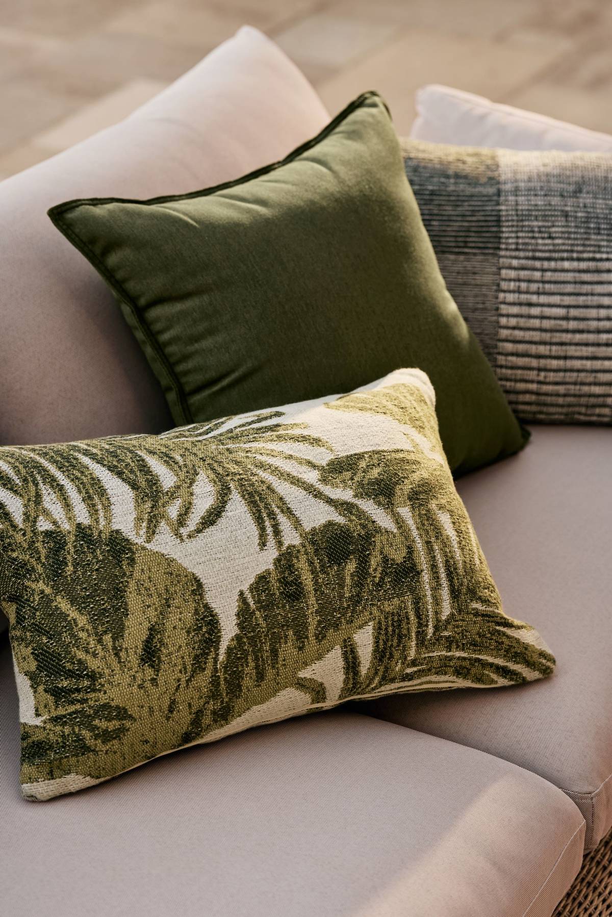 Jacquard palm leaf pillows evoke the outdoor vibe.