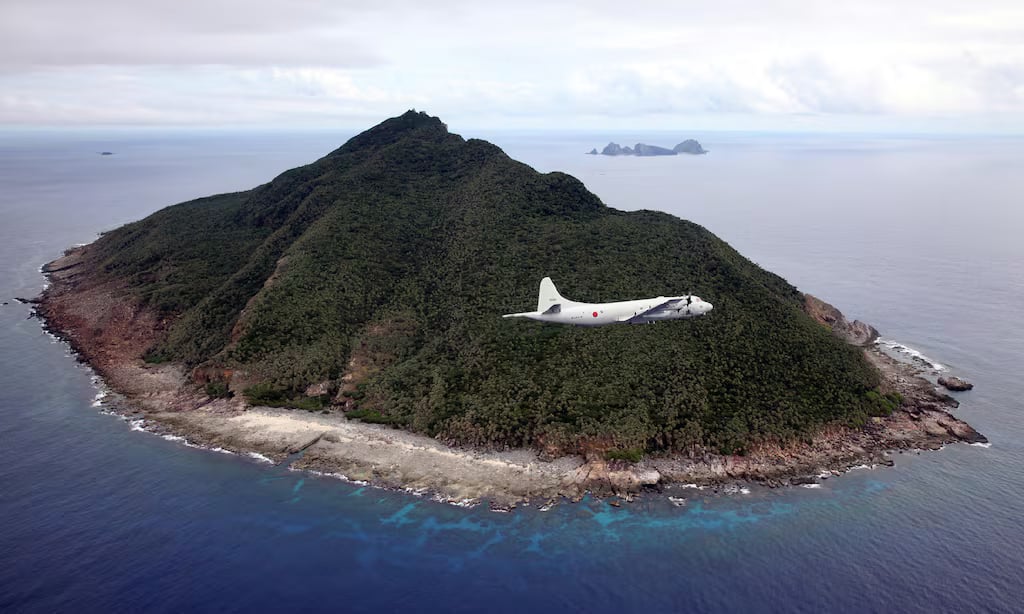 This photo taken on October 13, 2011 shows a P-3C patrol plane of Japanese Maritime Self-Defense Force flying over the disputed islets known as the Senkaku islands in Japan and Diaoyu islands in China, in the East China Sea. Japanese military and paramilitary planes have flown through China's newly declared air zone without any resistance from Chinese jets, an official and a report said on November 28, 2013. AFP PHOTO / JAPAN POOL via JIJI PRESS JAPAN OUT