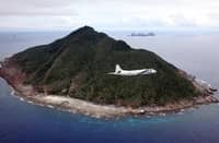 This photo taken on October 13, 2011 shows a P-3C patrol plane of Japanese Maritime Self-Defense Force flying over the disputed islets known as the Senkaku islands in Japan and Diaoyu islands in China, in the East China Sea. Japanese military and paramilitary planes have flown through China's newly declared air zone without any resistance from Chinese jets, an official and a report said on November 28, 2013. AFP PHOTO / JAPAN POOL via JIJI PRESS JAPAN OUT