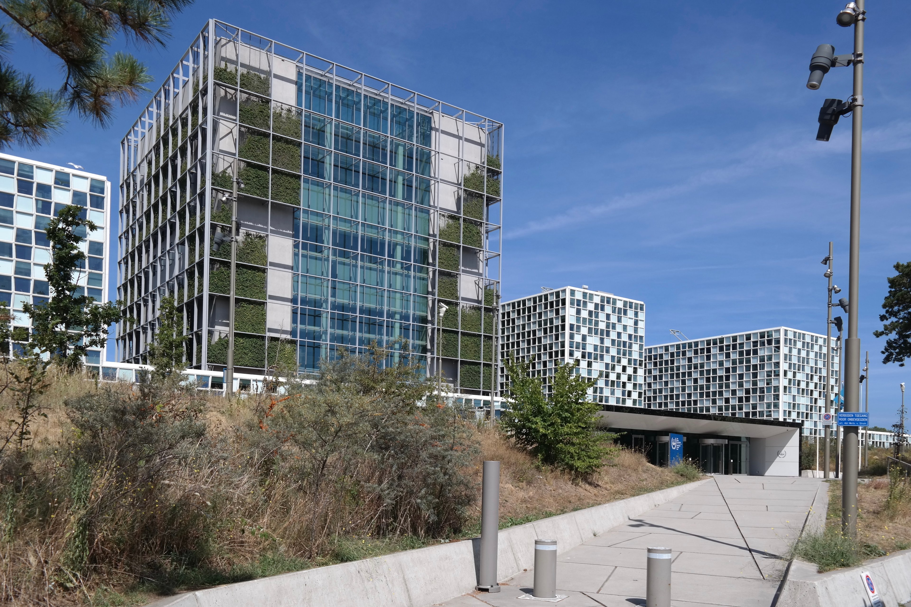 The modern premises of the International Criminal Court (ICC) in The Hague, Netherlands, featuring glass-and-steel architecture with vertical greenery. The ICC relocated to this building in December 2015.