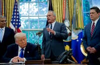 WASHINGTON, DC – U.S. Health and Human Services Secretary Robert F. Kennedy Jr. (C), accompanied by U.S. President Donald Trump (2nd-L) National Institutes of Health Director Jayanta Bhattacharya (L), and Domestic Policy Council Director Vince Haley (R), speaks in the Oval Office at the White House on May 05, 2025 in Washington, DC. Trump signed new proclamations and executive orders, including one that ends federal funding for so-called “gain-of-function” studies, which explores the use of microorganisms to alter biological functions in the aid of gene products.