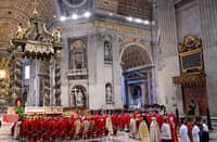 Cardinals in red vestments gather at St. Peter’s Basilica in the Vatican for the Seventh Novemdiale Mass on 2 May 2025, following the funeral of Pope Francis and ahead of the papal conclave.