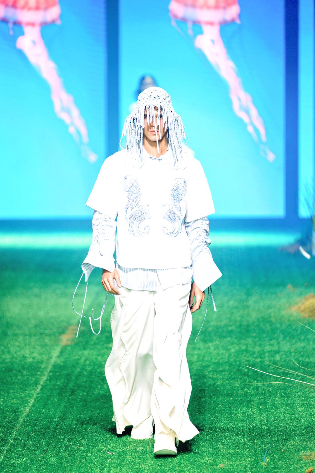 An embroidered jellyfish with its tentacles hanging loose from the front of the shirt.