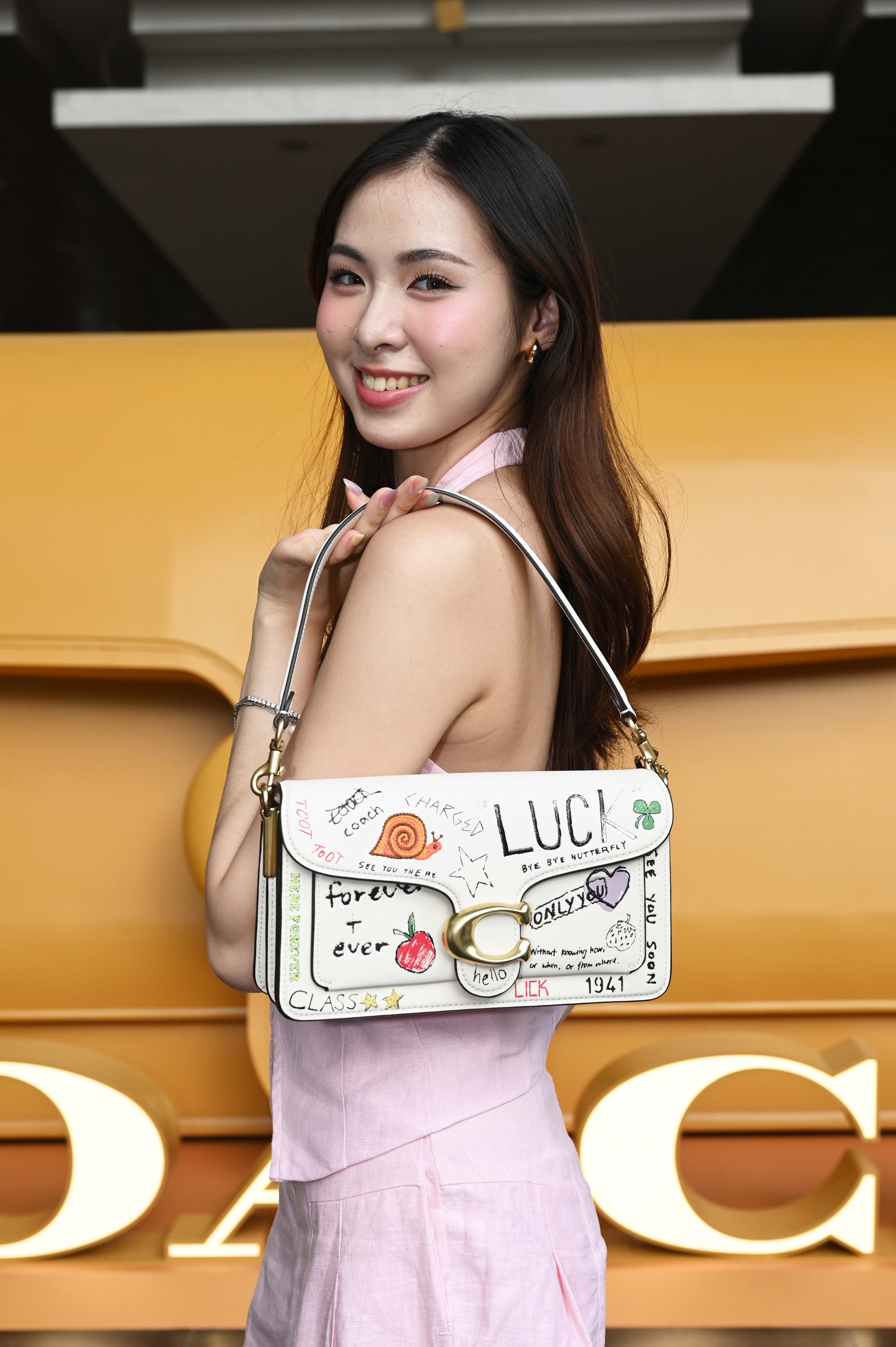 Jocelyn Yang with the Coach Tabby Shoulder Bag 26 with Sketch Print.