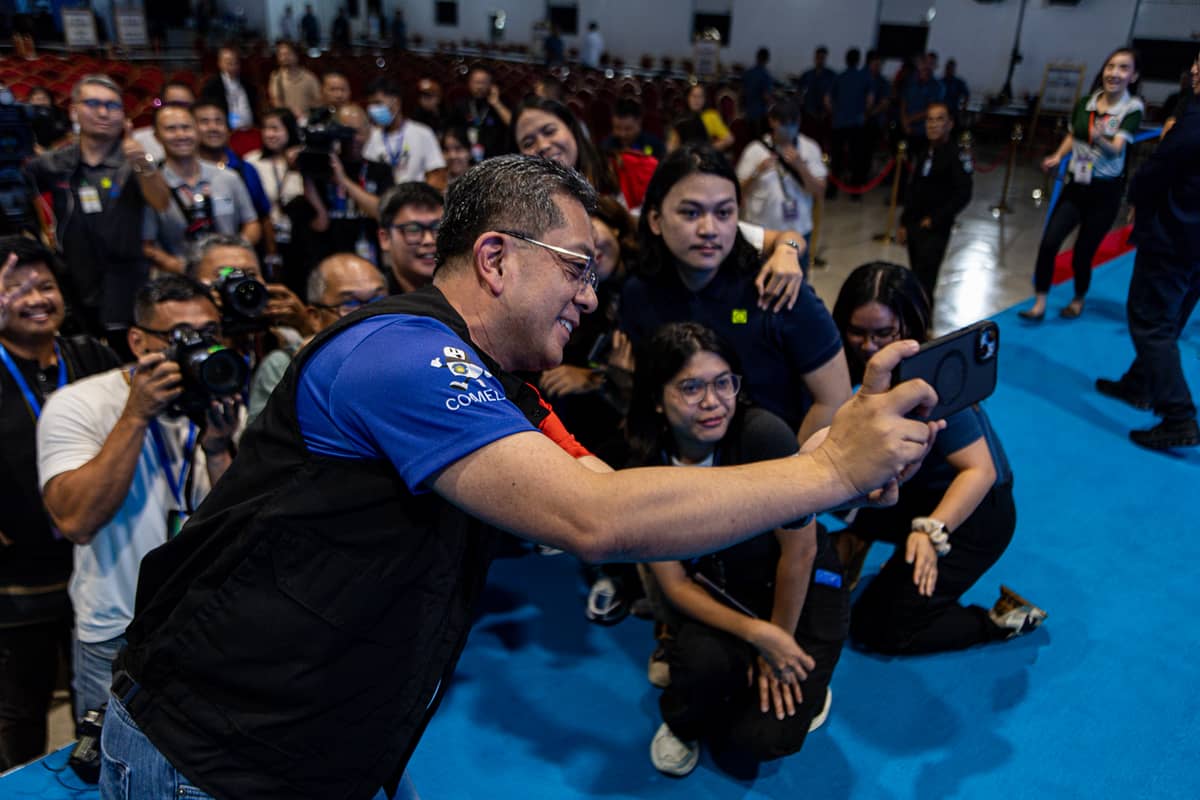 Quiet before the storm? Commission on Elections Chair George Garcia humors the press with a group photo on Sunday — the calm before what may become one of the most divisive midterm elections in recent memory.